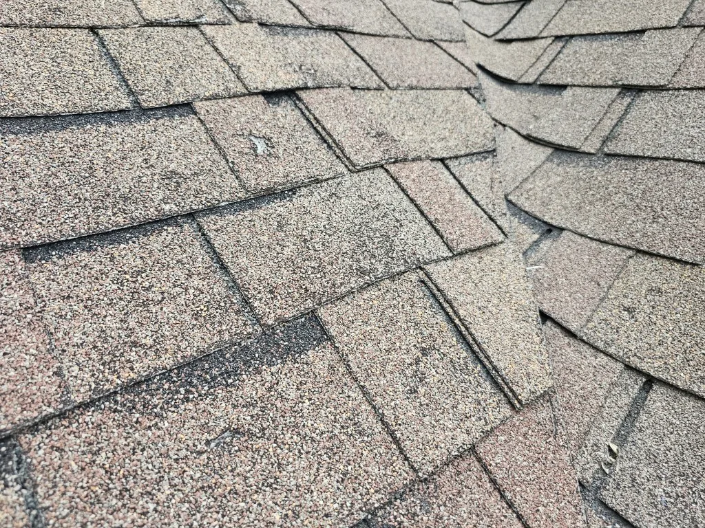 Hail damaged shingles on a Prior Lake MN roof before replacement